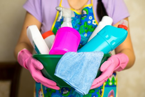 Cleaner working in a Kentishtown flat with compact rooms and stairs