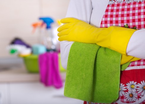 Cleaner working on dust and residue removal after renovation in Kentishtown